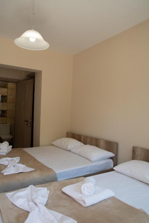 two beds in a room with towels on the floor at Olympic Coast in Olympic Beach