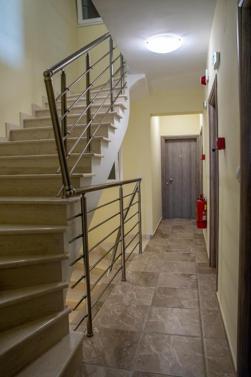 a staircase with a metal railing in a hallway at Olympic Coast in Olympic Beach