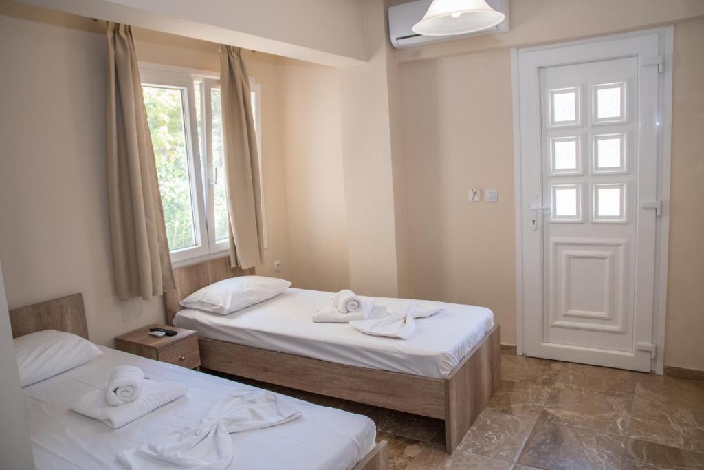 a bedroom with two beds with towels on them at Olympic Coast in Olympic Beach