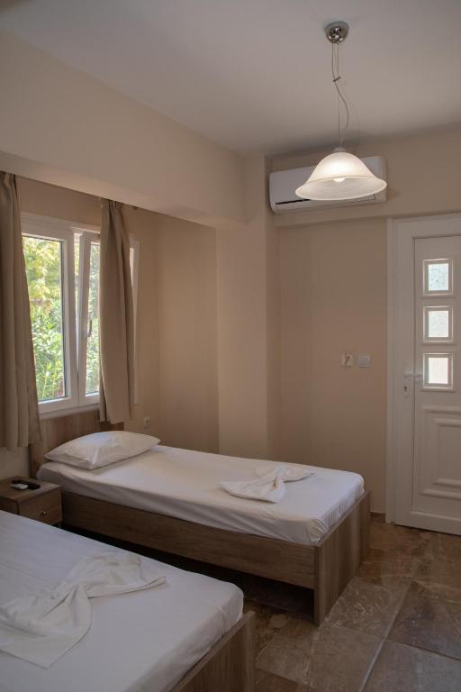 a bedroom with two beds and a window and a light at Olympic Coast in Olympic Beach
