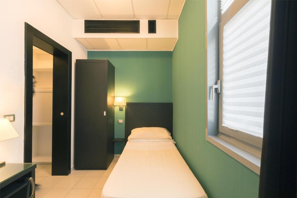 Postel nebo postele na pokoji v ubytování Executive Business Hotel