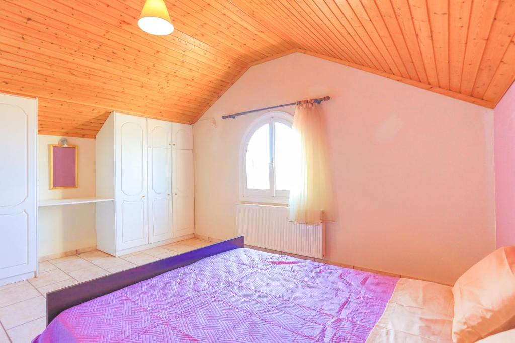 Postel nebo postele na pokoji v ubytování Villa Eftihia