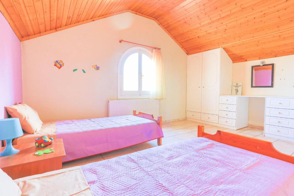 Postel nebo postele na pokoji v ubytování Villa Eftihia