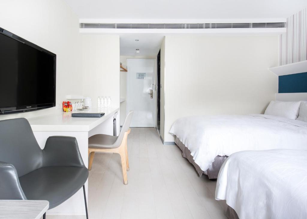 Postel nebo postele na pokoji v ubytování Dandy Hotel - Tianmu Branch