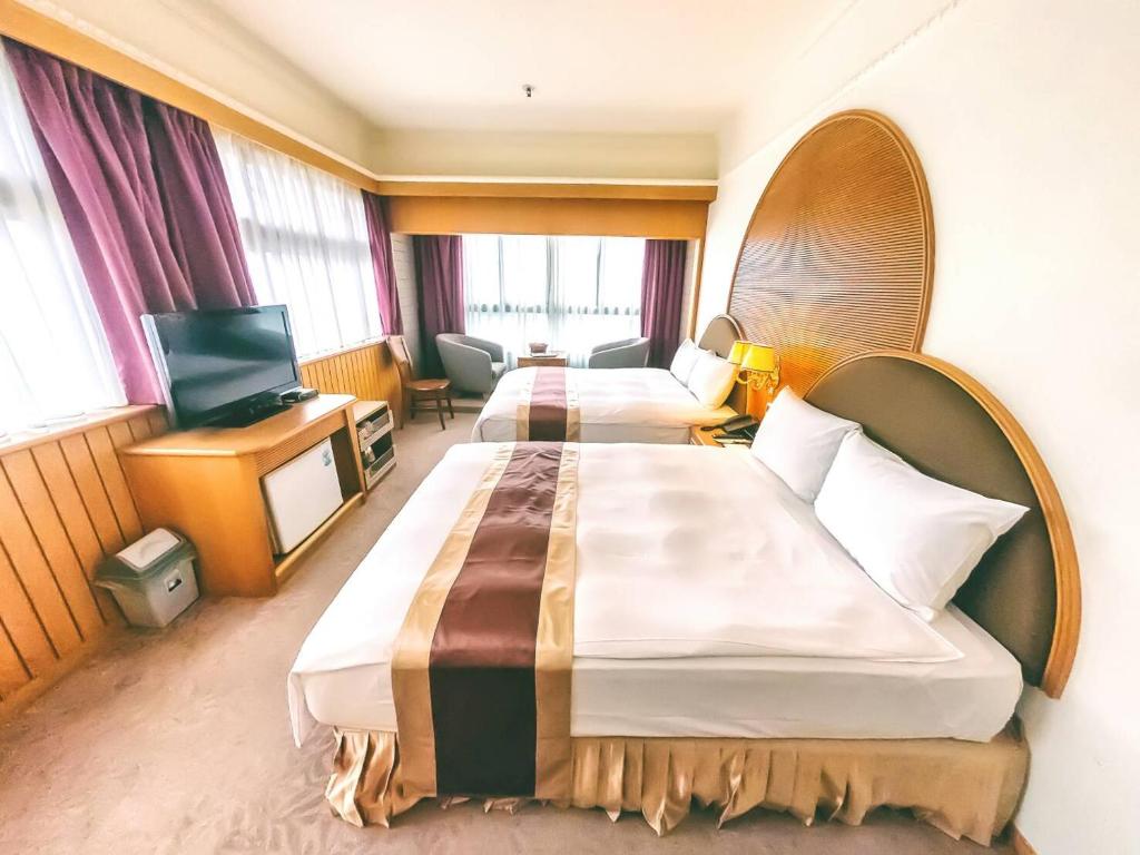 Postel nebo postele na pokoji v ubytování Foung Jia Hotel