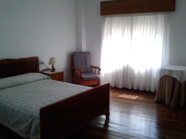 A bed or beds in a room at Hostal Pumar