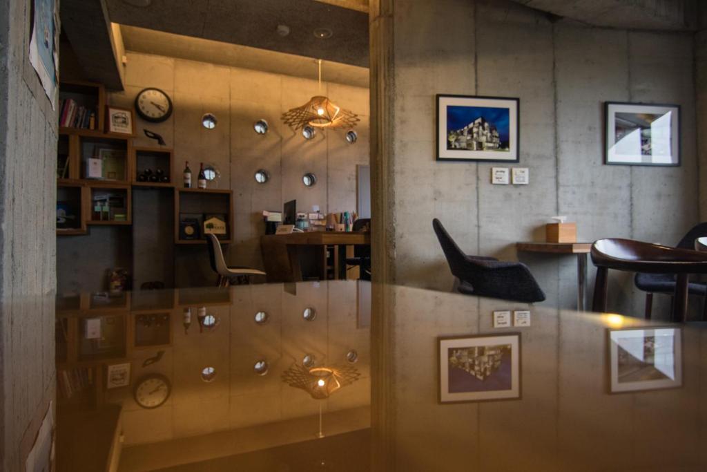 a room with a table and chairs and a glass window at The Light in Hengchun South Gate