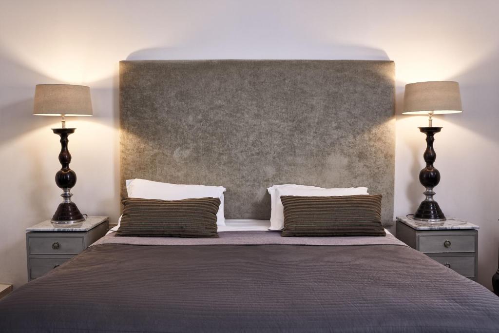 A bed or beds in a room at Emporikon Athens Hotel