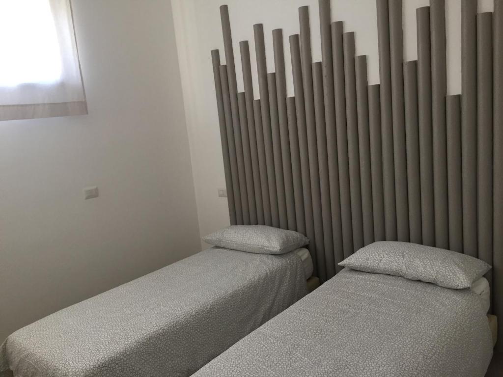 A bed or beds in a room at Rosy House - Hospitality