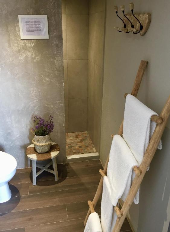 a bathroom with a shower with a towel at Hostal Sa Malica in Blanes