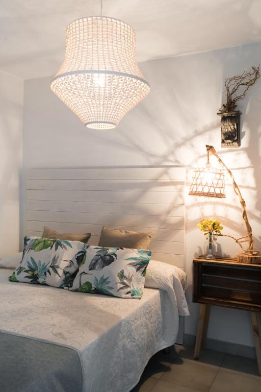 a bedroom with a bed with a lamp and a table at Hostal Sa Malica in Blanes