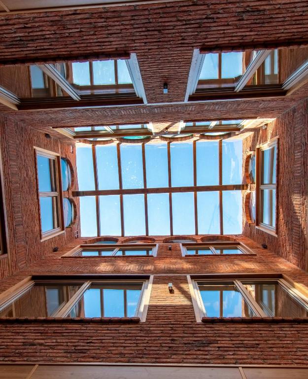 a view of the ceiling of a building with windows at Hotel Gastronómico Torre de Galizano in Galizano