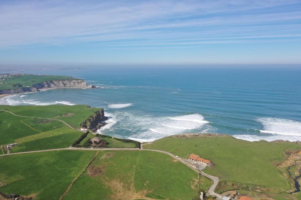an aerial view of a beach with the ocean at Hotel Gastronómico Torre de Galizano in Galizano