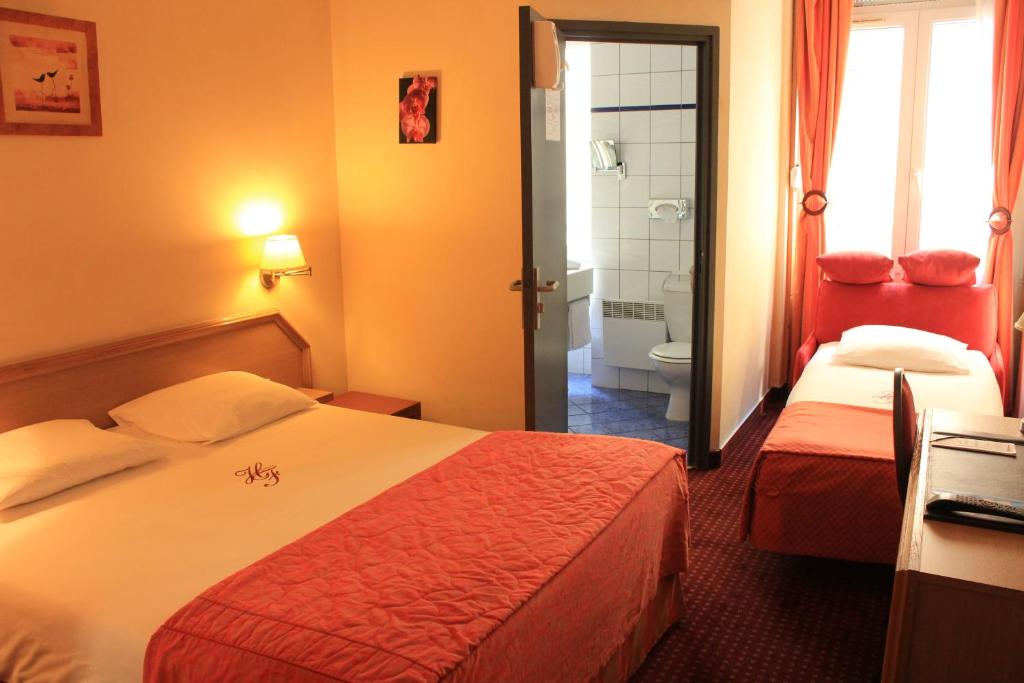 Postel nebo postele na pokoji v ubytování Hôtel Foch