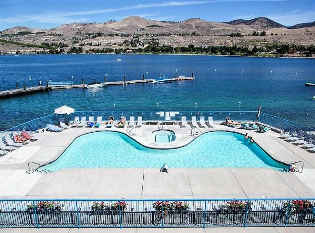 a large swimming pool in the middle of a lake at Chelan Resort Waterfront Townhouse in Chelan