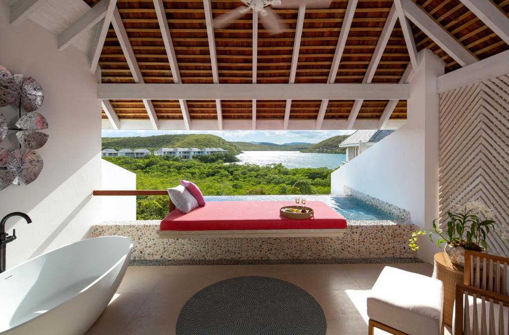 a bathroom with a red bathtub and a plunge pool at Escape at Nonsuch Bay Antigua - All Inclusive - Adults Only in Gaynors