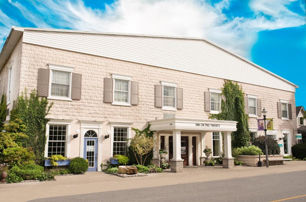 a large brick building on a street at Inn On The Twenty in Jordan