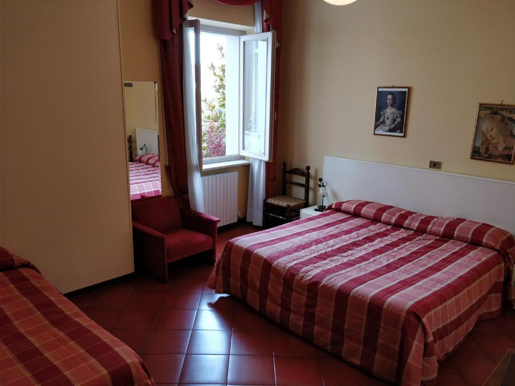 Postel nebo postele na pokoji v ubytování Hotel Barolo Classico