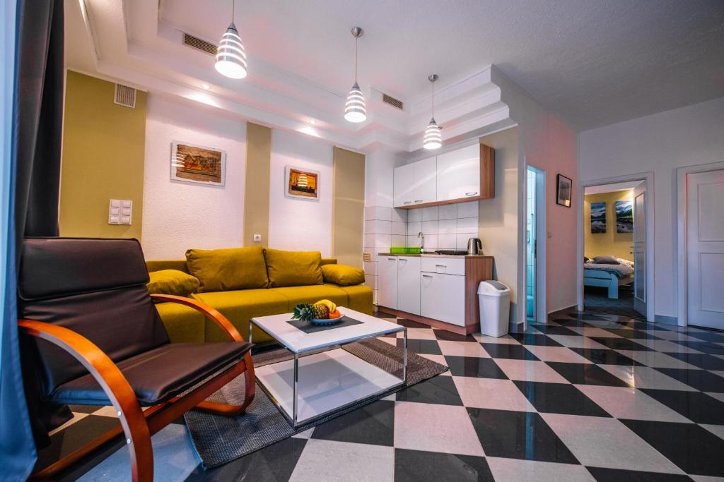 a living room with a yellow couch and a table at Apartman Luka in Livno