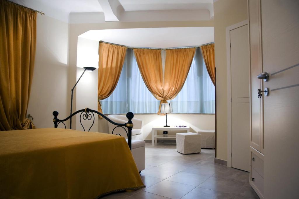 a bedroom with a yellow bed and a window at B&B Lepanto in Messina