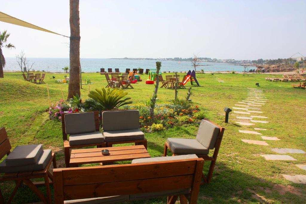 a group of chairs and tables in a park at Amphora Hotel & Suites in Paphos