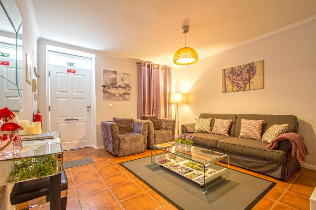 a living room with a couch and a table at Old Town House Madeira in Funchal