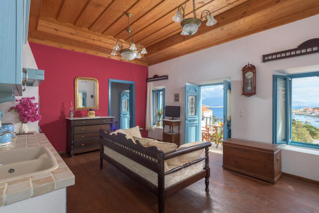 a large bathroom with a couch and a sink at Villa Katingo in Halki