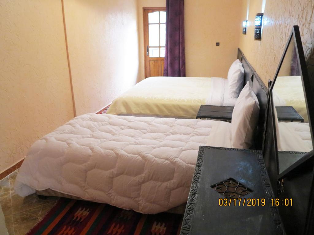 Postel nebo postele na pokoji v ubytování Kasbah Imoula