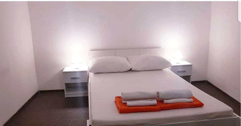 a bedroom with a white bed with two pillows on it at David 3 in Pula