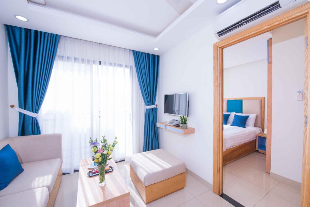 a hotel room with a bed and a mirror at Sincero Hotel & Apartment in Da Nang