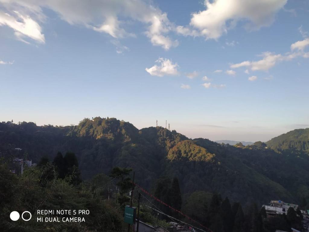 a view of a mountain range with the sky at Langdak Homestay in Darjeeling