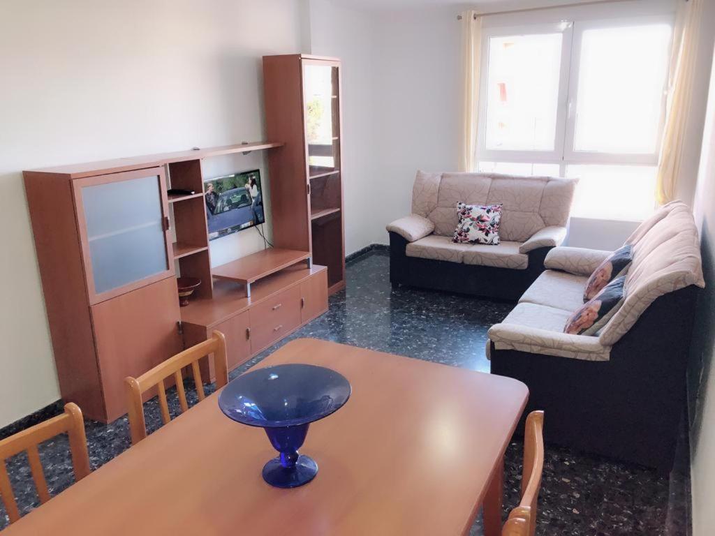 a living room with a table and a couch and a tv at Avenida de Daniel Gil 72 - 2º - 7ª in Ontinyent
