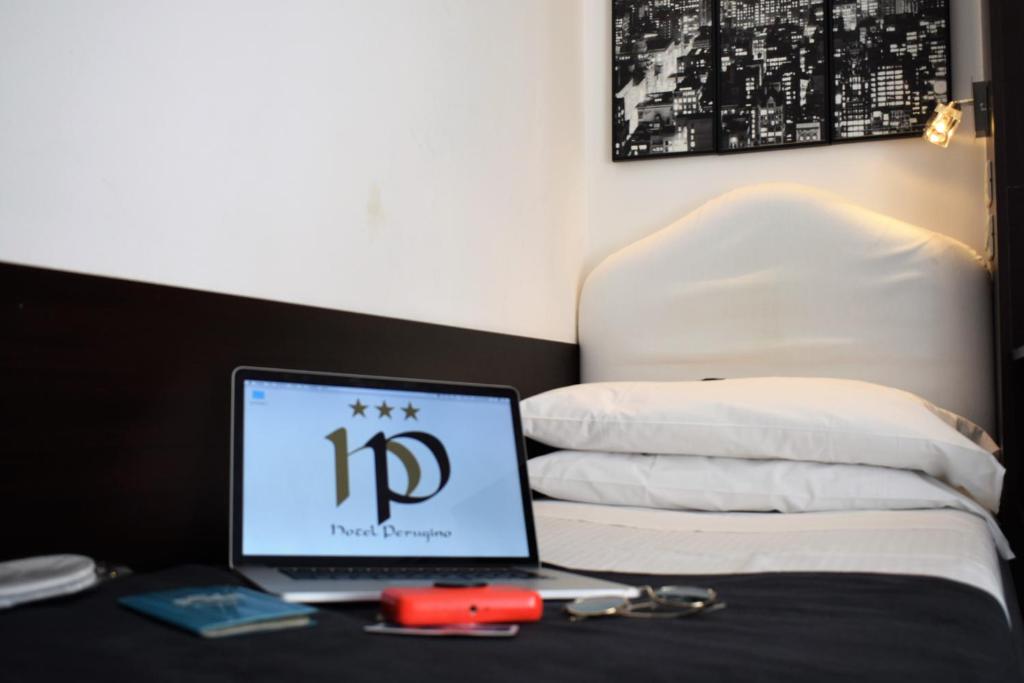 Postel nebo postele na pokoji v ubytování Hotel Perugino