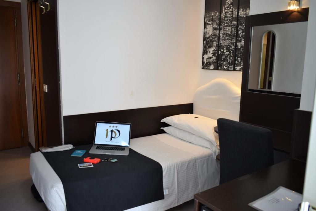 Postel nebo postele na pokoji v ubytování Hotel Perugino