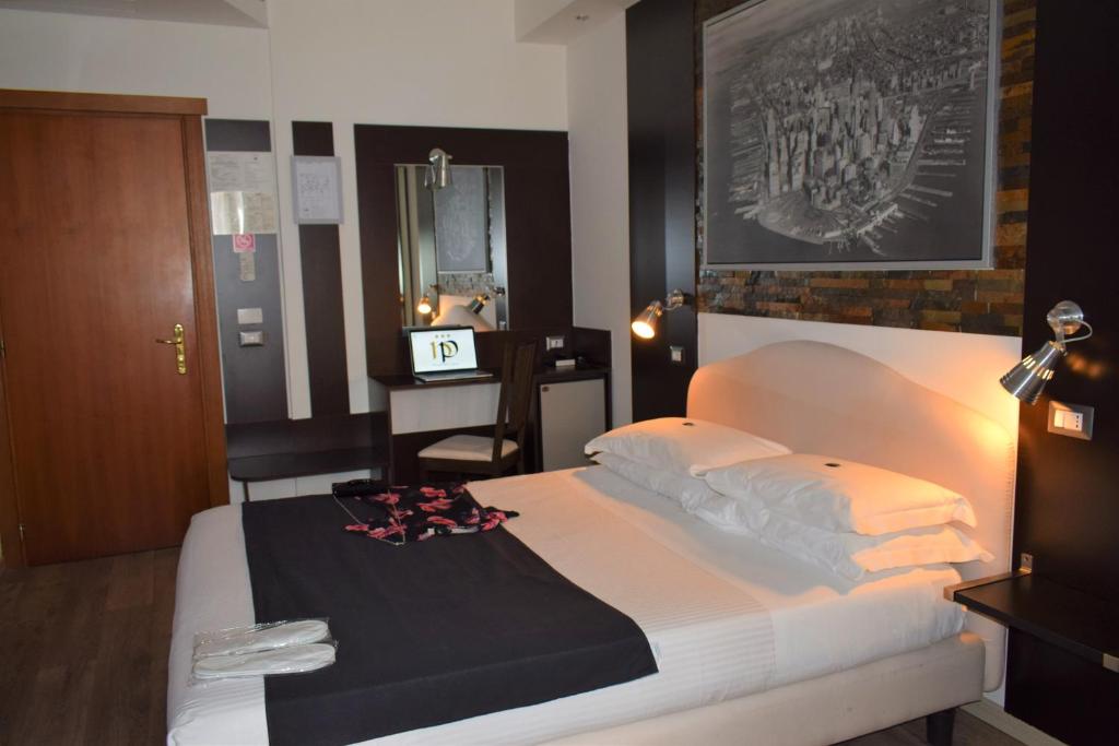 Postel nebo postele na pokoji v ubytování Hotel Perugino