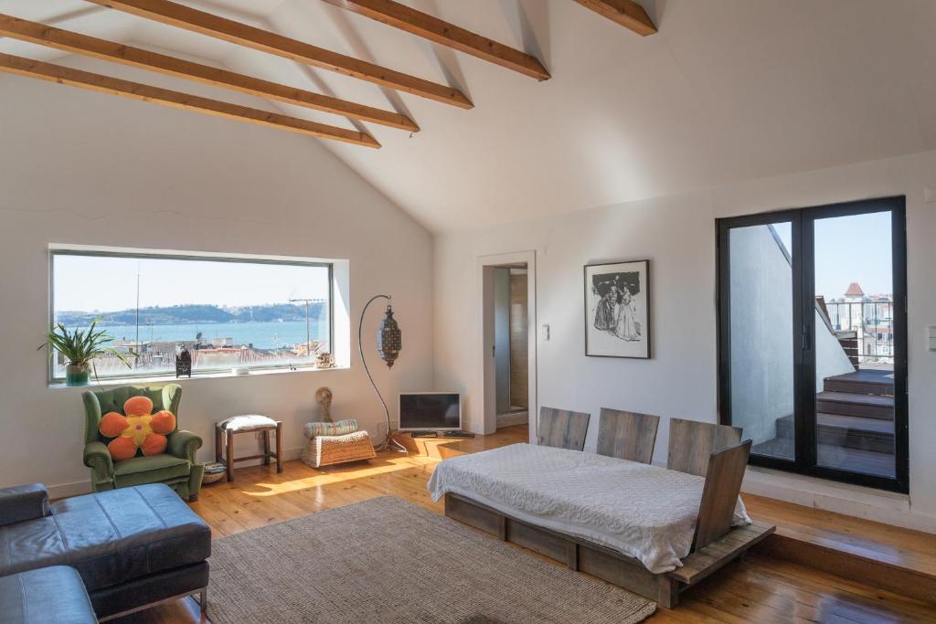 a living room with a couch and a large window at FLH Chiado Skyline in Lisbon