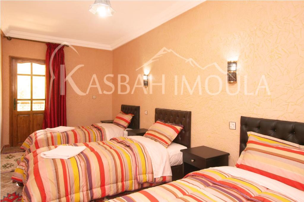 Postel nebo postele na pokoji v ubytování Kasbah Imoula