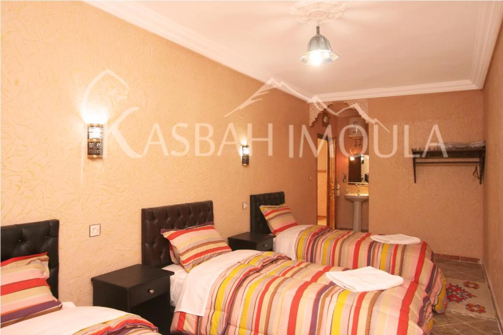 Postel nebo postele na pokoji v ubytování Kasbah Imoula
