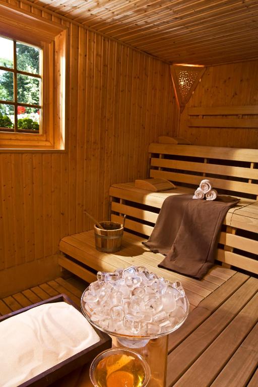 a sauna with two beds and a table with a tray at Ensana Thermal Hévíz in Hévíz