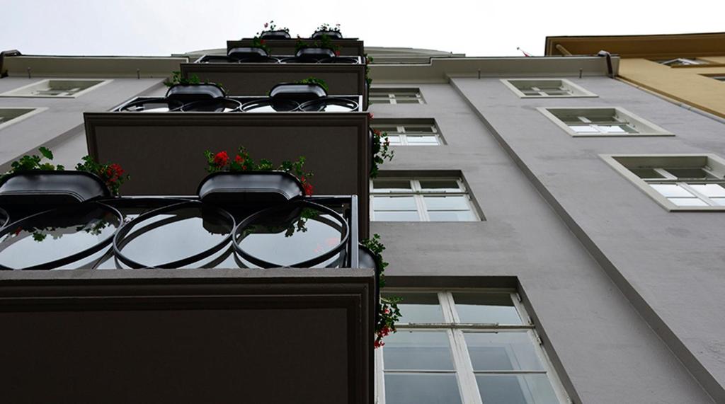 a building with flower pots on the side of it at Hotel No13 in Bergen
