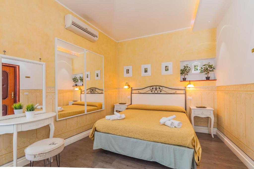 a bedroom with a bed and a large mirror at Albergo Della Corte in Benevento