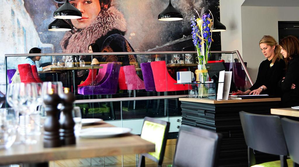a restaurant with purple and red boots on a wall at Hotel No13 in Bergen