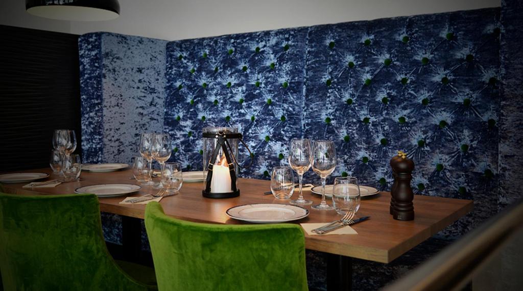 a wooden table with wine glasses and a kettle at Hotel No13 in Bergen