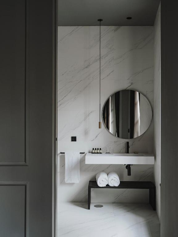 a bathroom with a sink and a mirror at El Môderne Hotel in Gijón