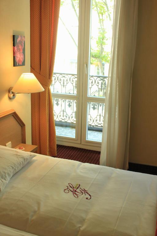 Postel nebo postele na pokoji v ubytování Hôtel Foch