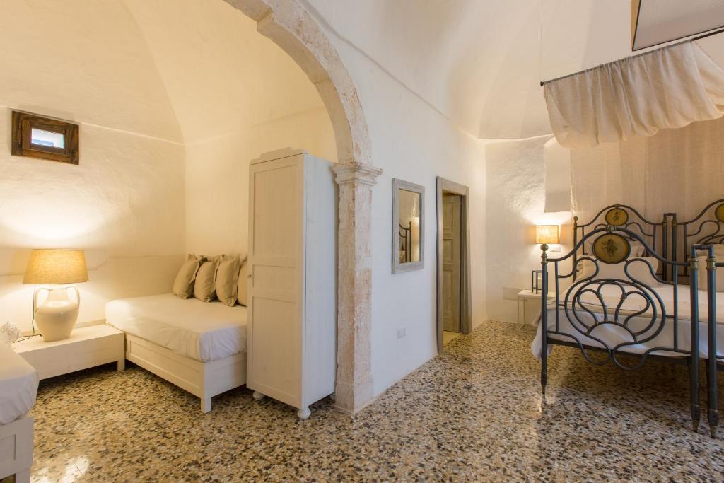 Postel nebo postele na pokoji v ubytování Masseria Castelluzzo