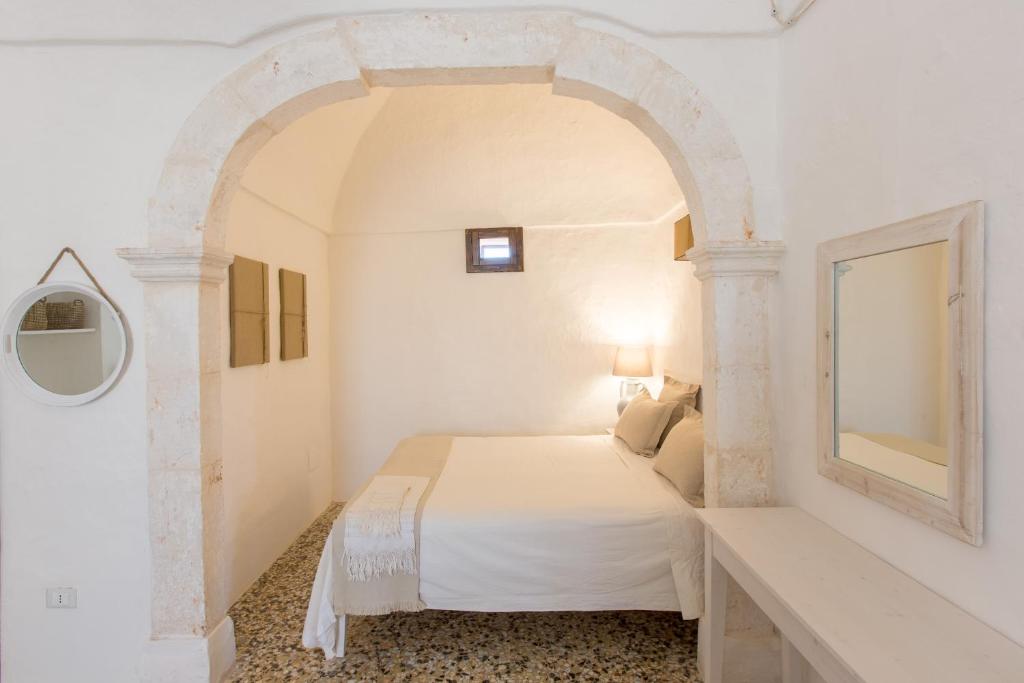 Postel nebo postele na pokoji v ubytování Masseria Castelluzzo