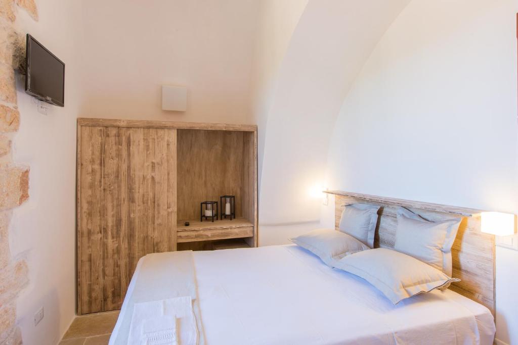 Postel nebo postele na pokoji v ubytování Masseria Castelluzzo
