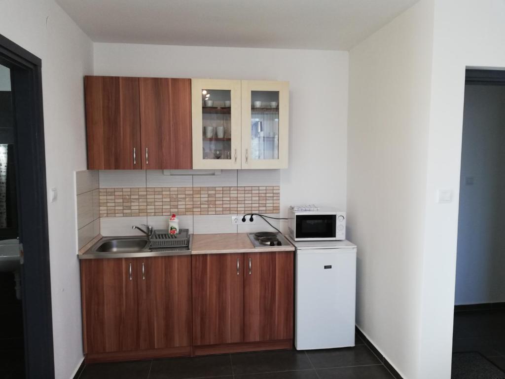 Kuchyň nebo kuchyňský kout v ubytování Apartman 25