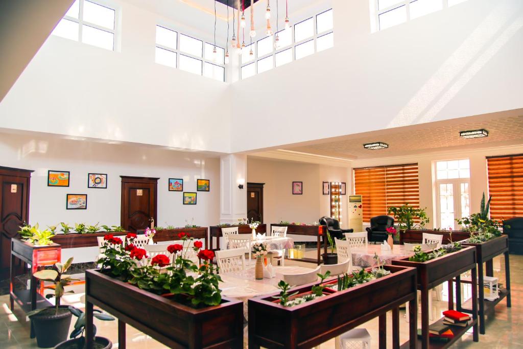 Cette chambre comprend une grande table avec des fleurs. dans l'établissement Casa de Higos, à Samarcande
